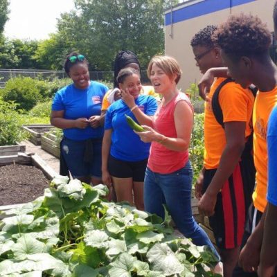 While gardening at the Worcester Youth Center, Attorney General Maura Healey talks with the youths about their involvement in the center and their future career aspirations. (Kaylee Johnston photo)